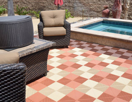 patio with wicker furniture and neatly tiled water feature on a checker patterned Swisstrax tile floor