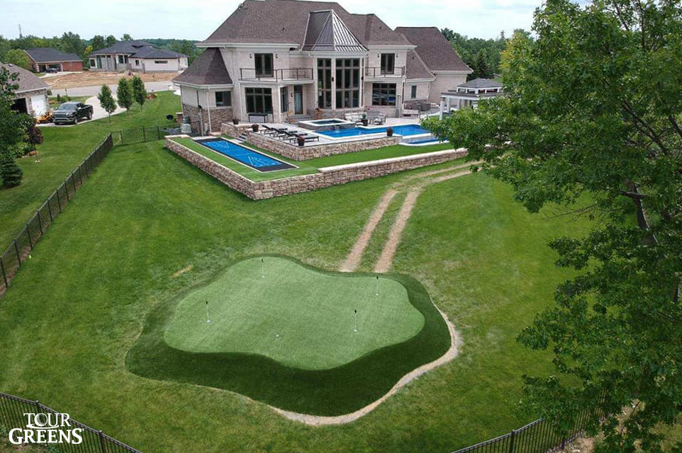 Large backyard with a Tour Greens putting green and shuffleboard court