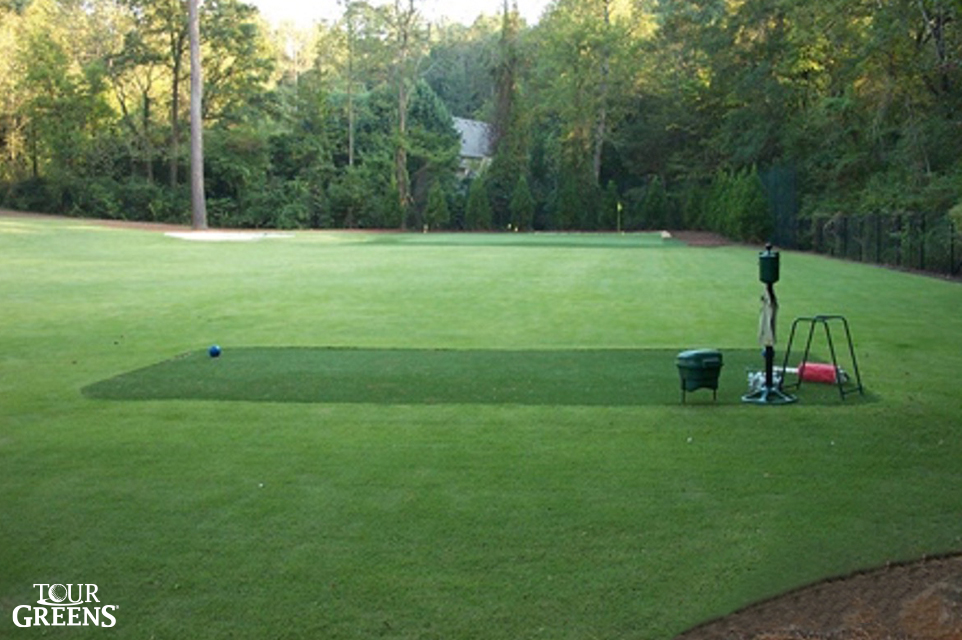 Backyard open space with a Tour Greens hitting mat and short game green installed