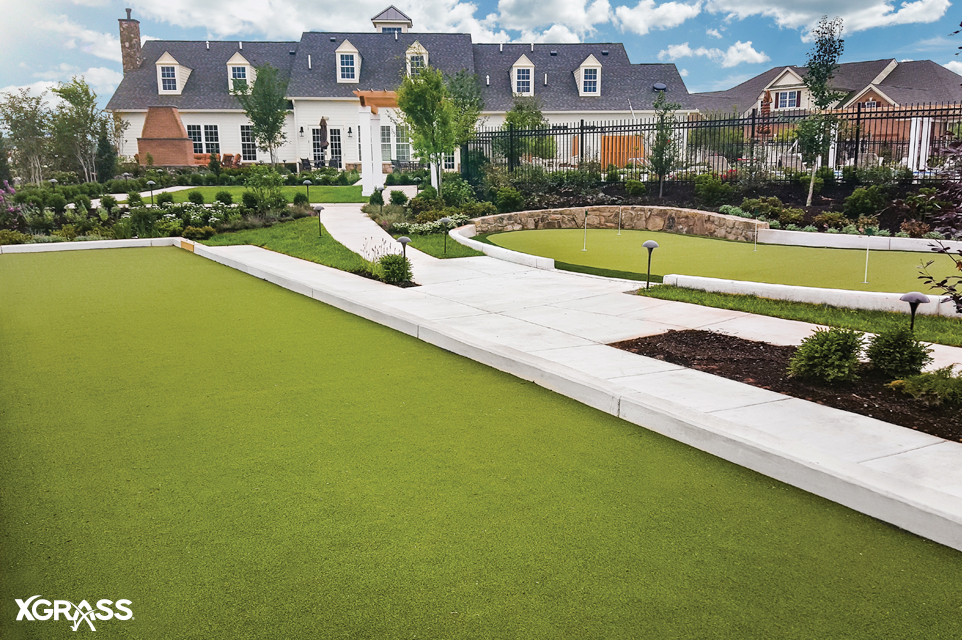 Large backyard with artificial turf bocce court and tour quality putting green installed