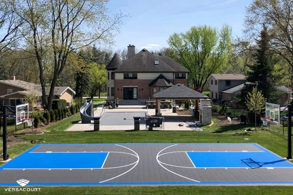 Backyard with a full-length basketball court from VersaCourt
