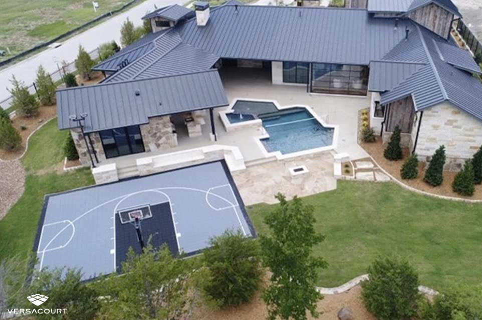 Large home installed with VersaCourt's backyard multi-sport court