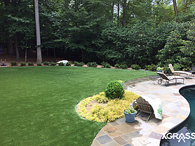 Artificial grass installed in the backyard next to pool
